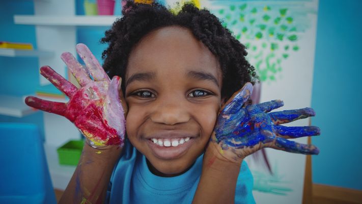 Kid with paint on hands