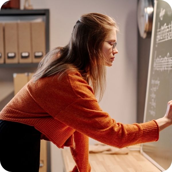 Teacher writing on a chalkboard