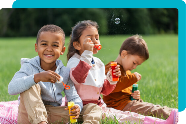 happy kids blowing bubbles