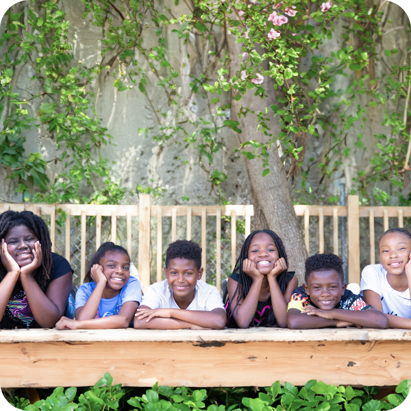 Group of kids smiling outside