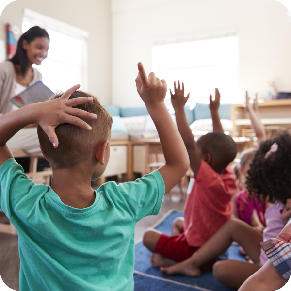 kids raising hands in class