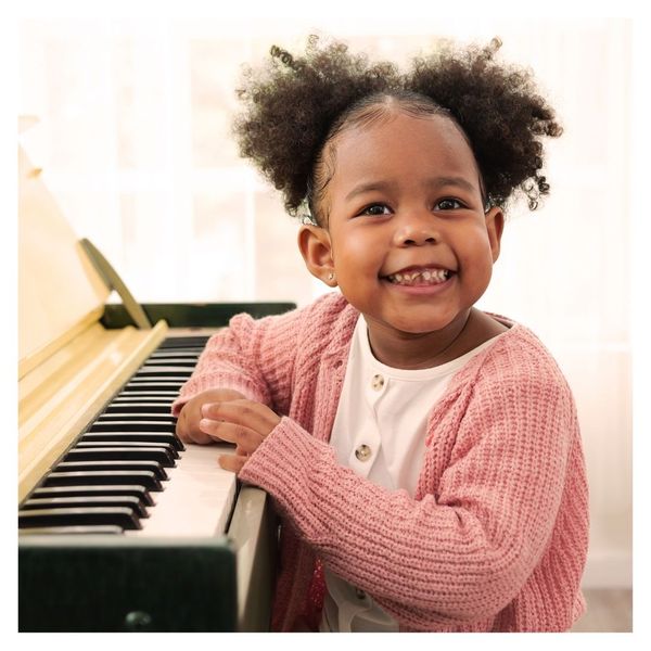 girl sitting at piano