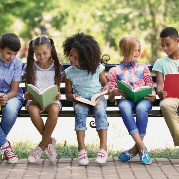 children reading on bench