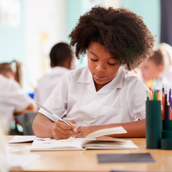 Student writing in a notebook