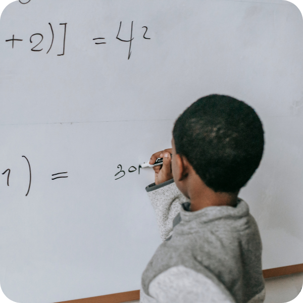 child working out a math problem