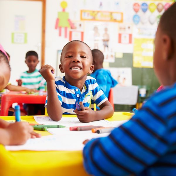 Kid smiling while drawing