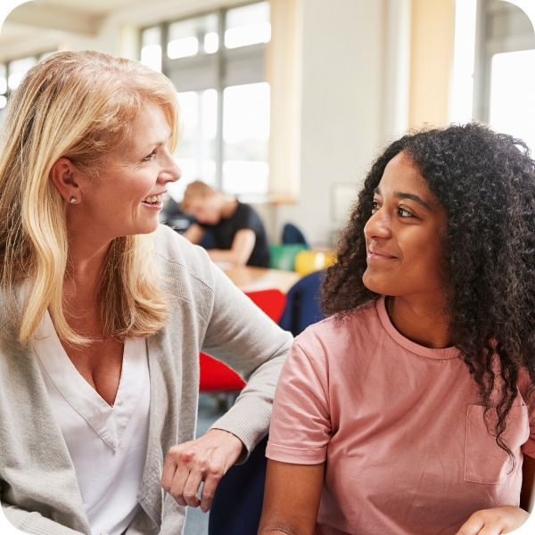 Teacher sitting with a student