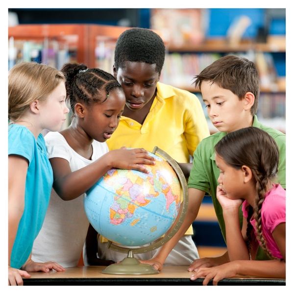 elementary students looking at globe