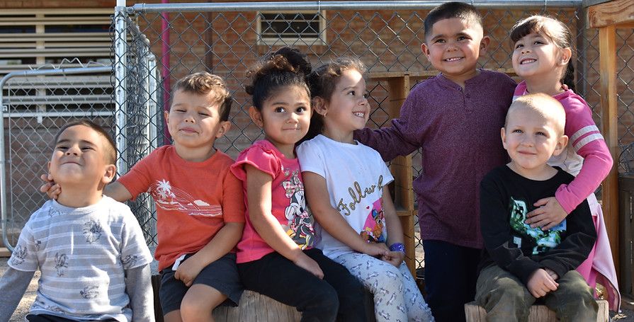 little kids posing on the playground