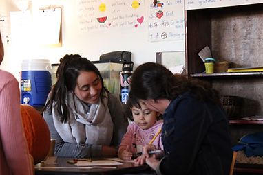 teachers with little girl