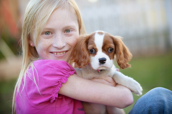 image of a girl and a puppy
