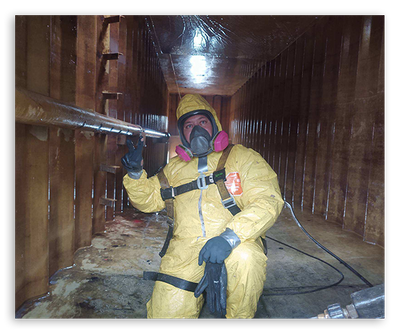 EMT worker in hazmat suit climbing through a narrow space