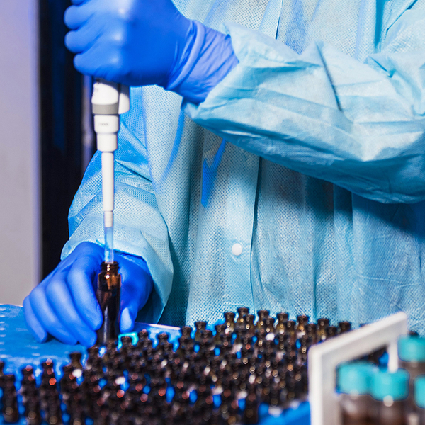 Lab assistant filling bottles