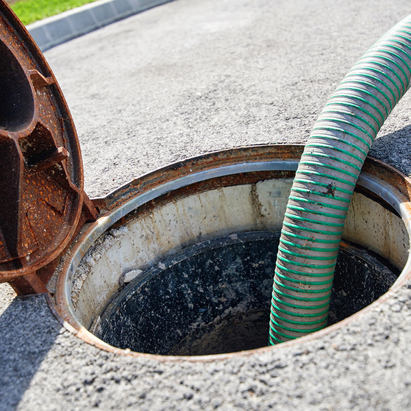 large hose going into septic tank below ground