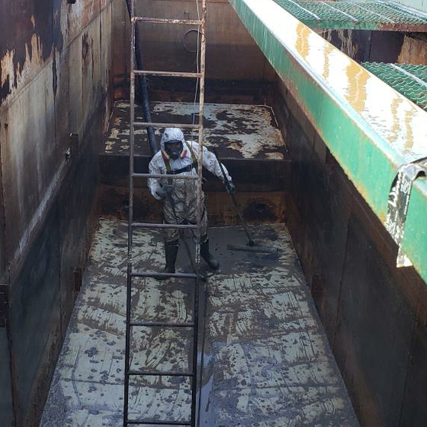 EMT worker  sweeping up a metal floor