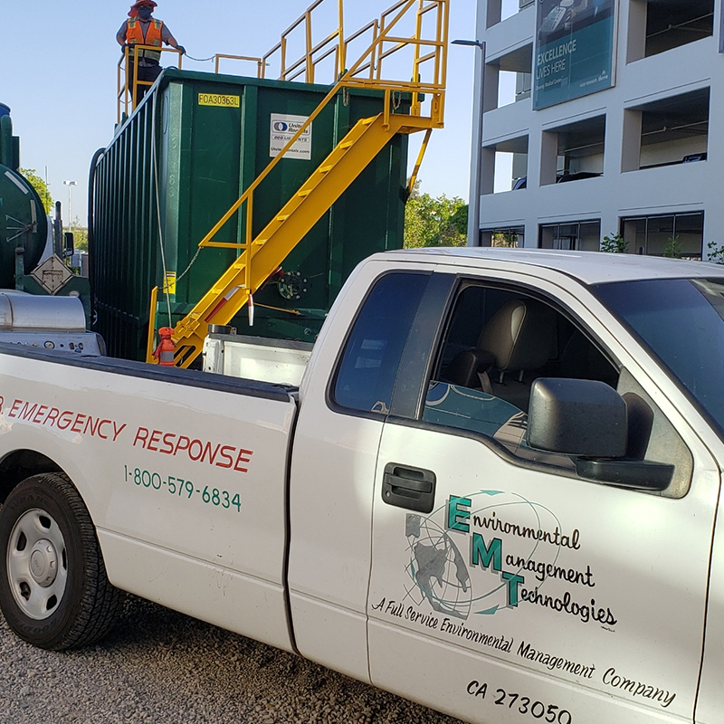 EMT truck with workers in the background