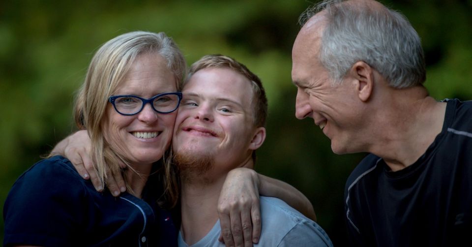 Couple with special needs child all happily smiling together