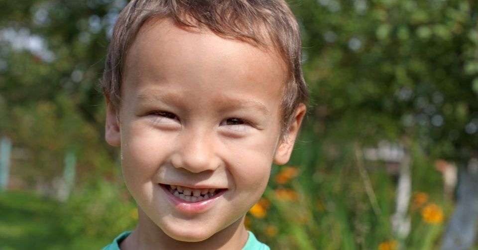 little boy smiling outdoors