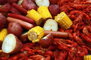 Boiled crawfish with corn, potatoes and hot dogs.