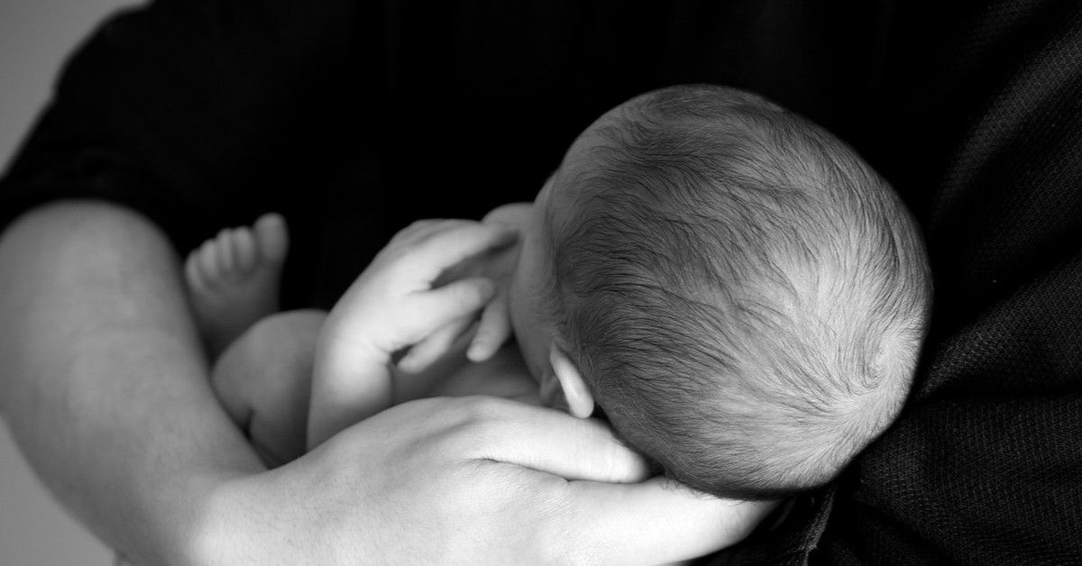 holding a newborn baby