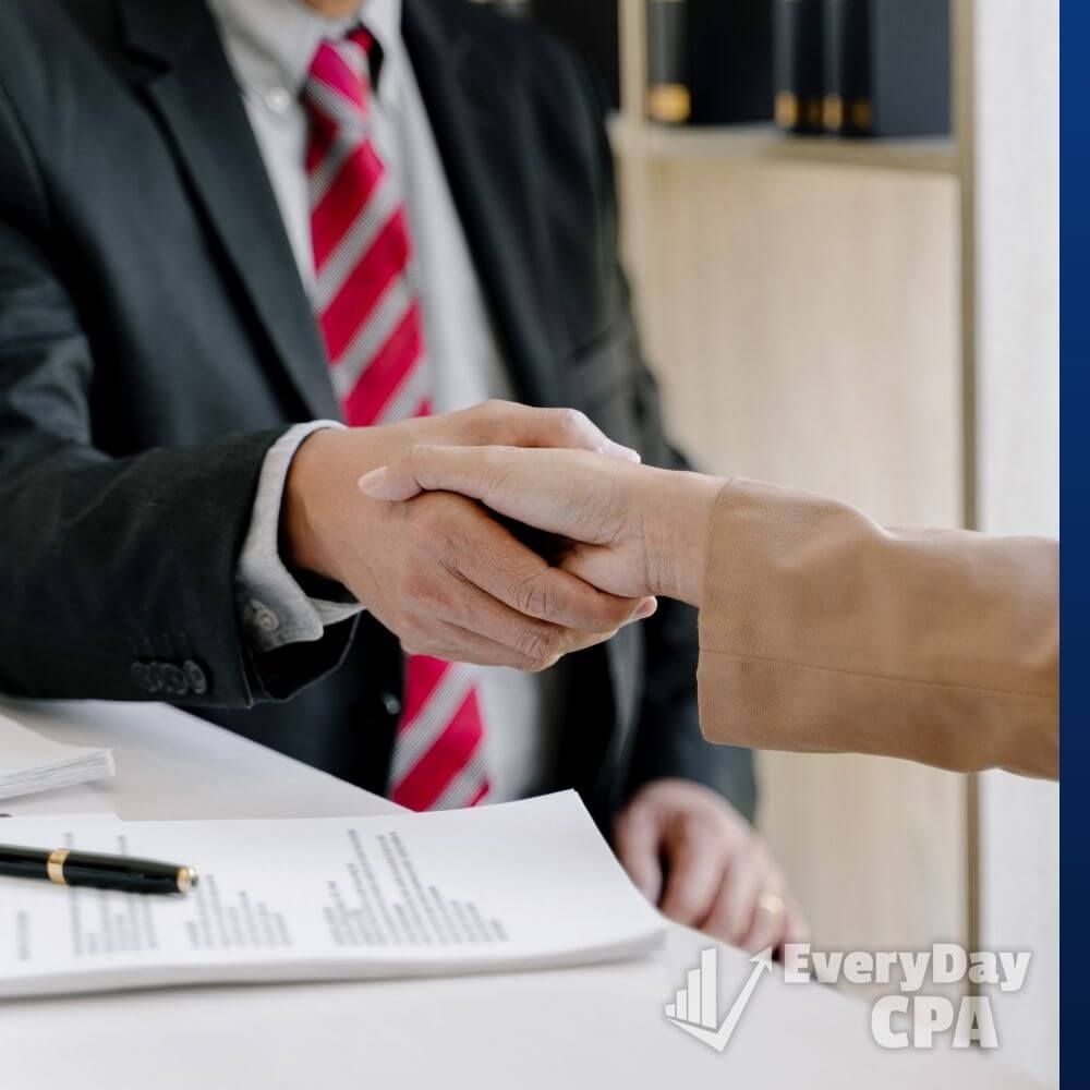 tax professional shaking hands with client tax professional shaking hands with client