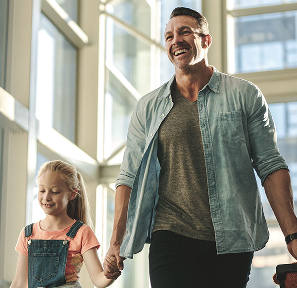 image of father holding daughters hand