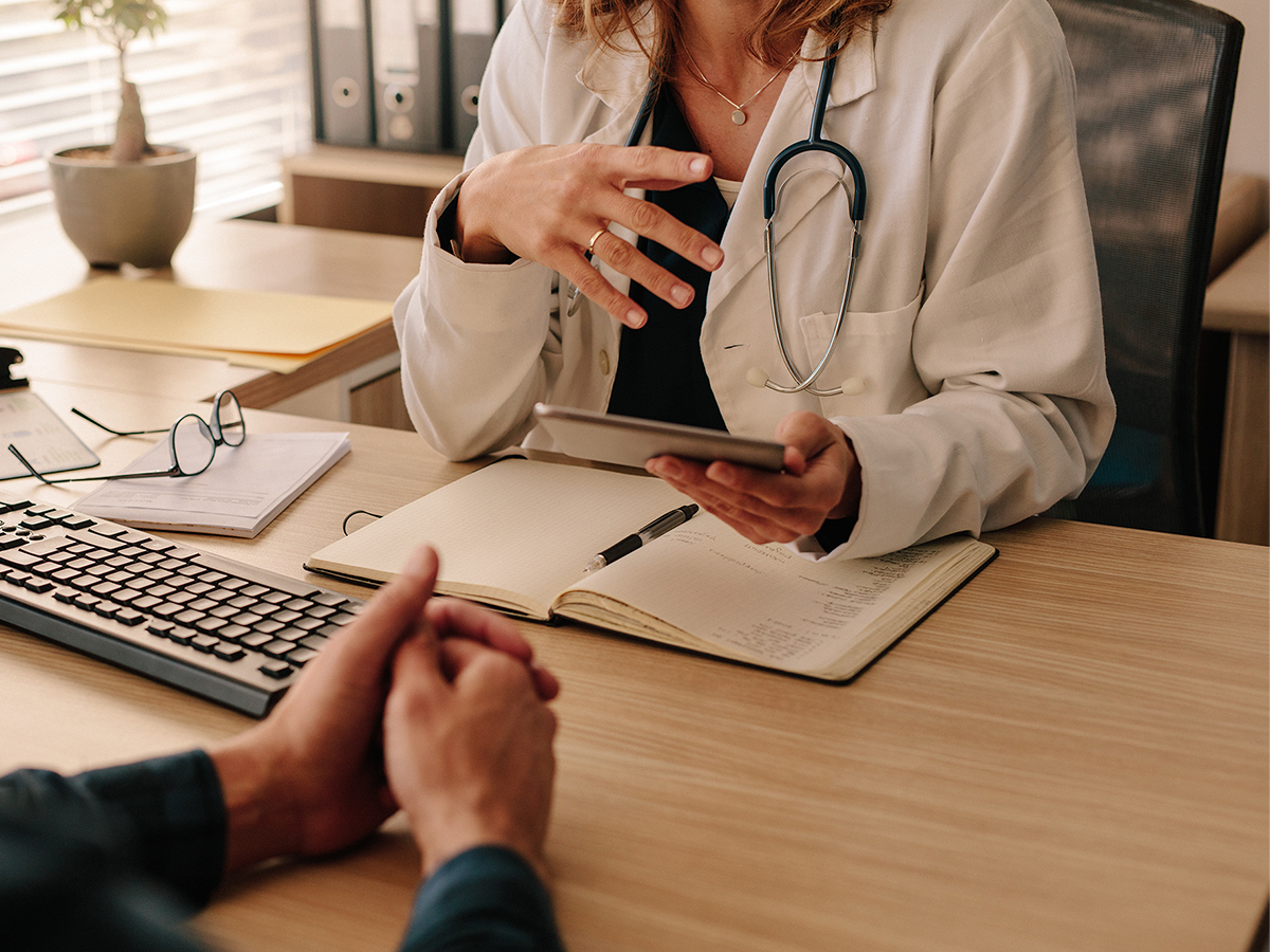 Doctor consulting with a patient in an office Doctor consulting with a patient in an office