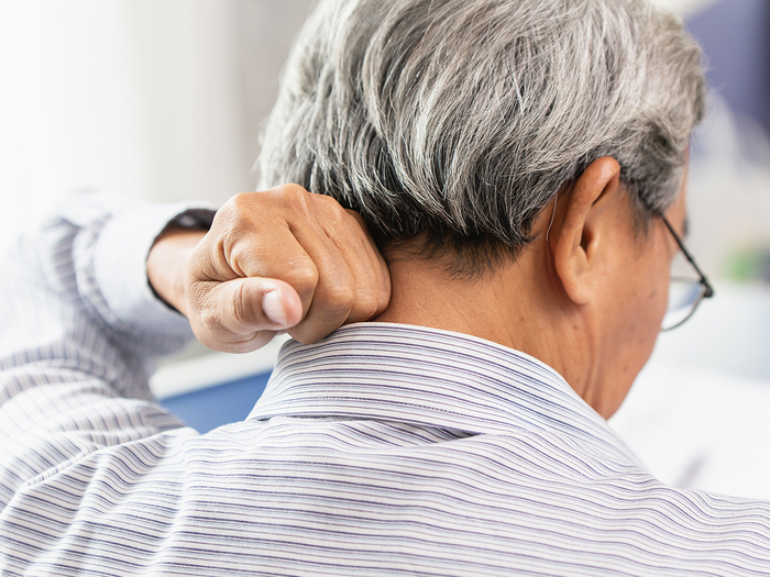 Man experiencing neck pain.