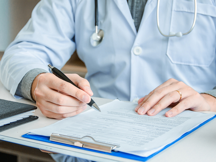 Doctor reviewing paperwork and planning patient care.