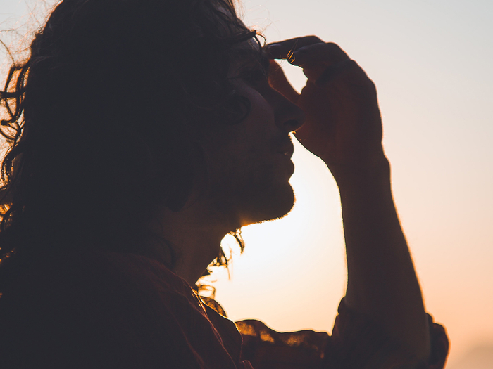 man holding his head in pain