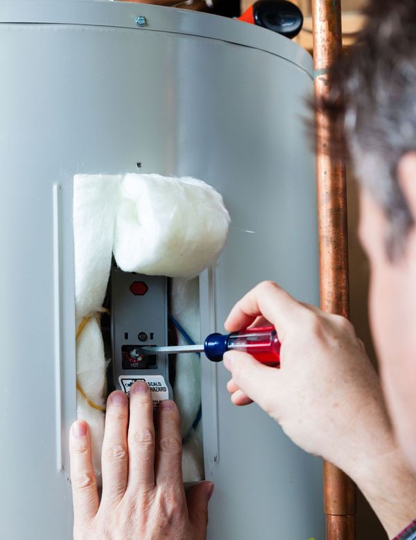 water heater maintenance with a screwdriver