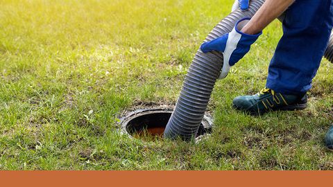 plumber pumping out sewer with hose