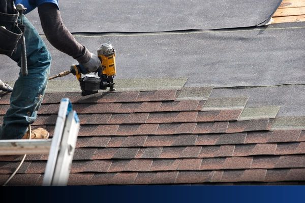 Roofers installing new roof on house