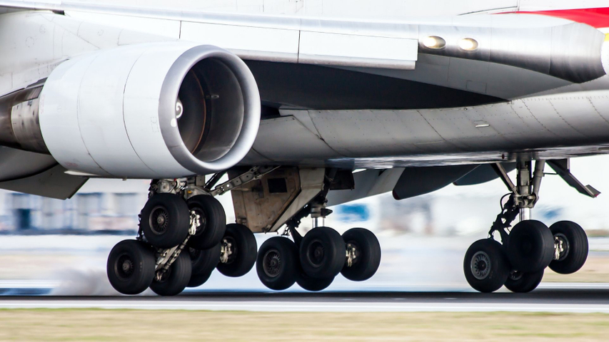 airplane landing gear as plane takes off
