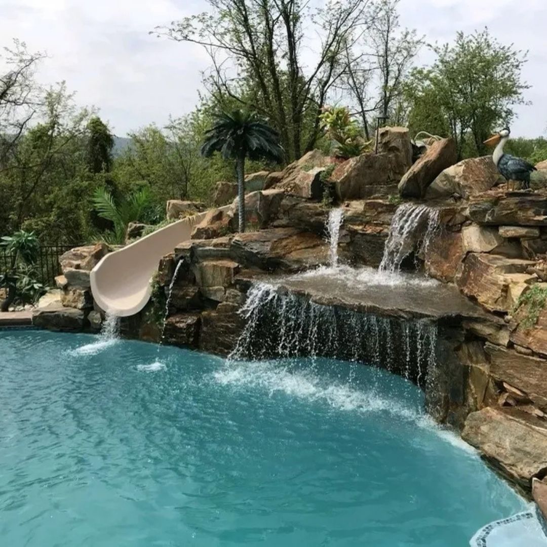 a water feature with a slide into a pool
