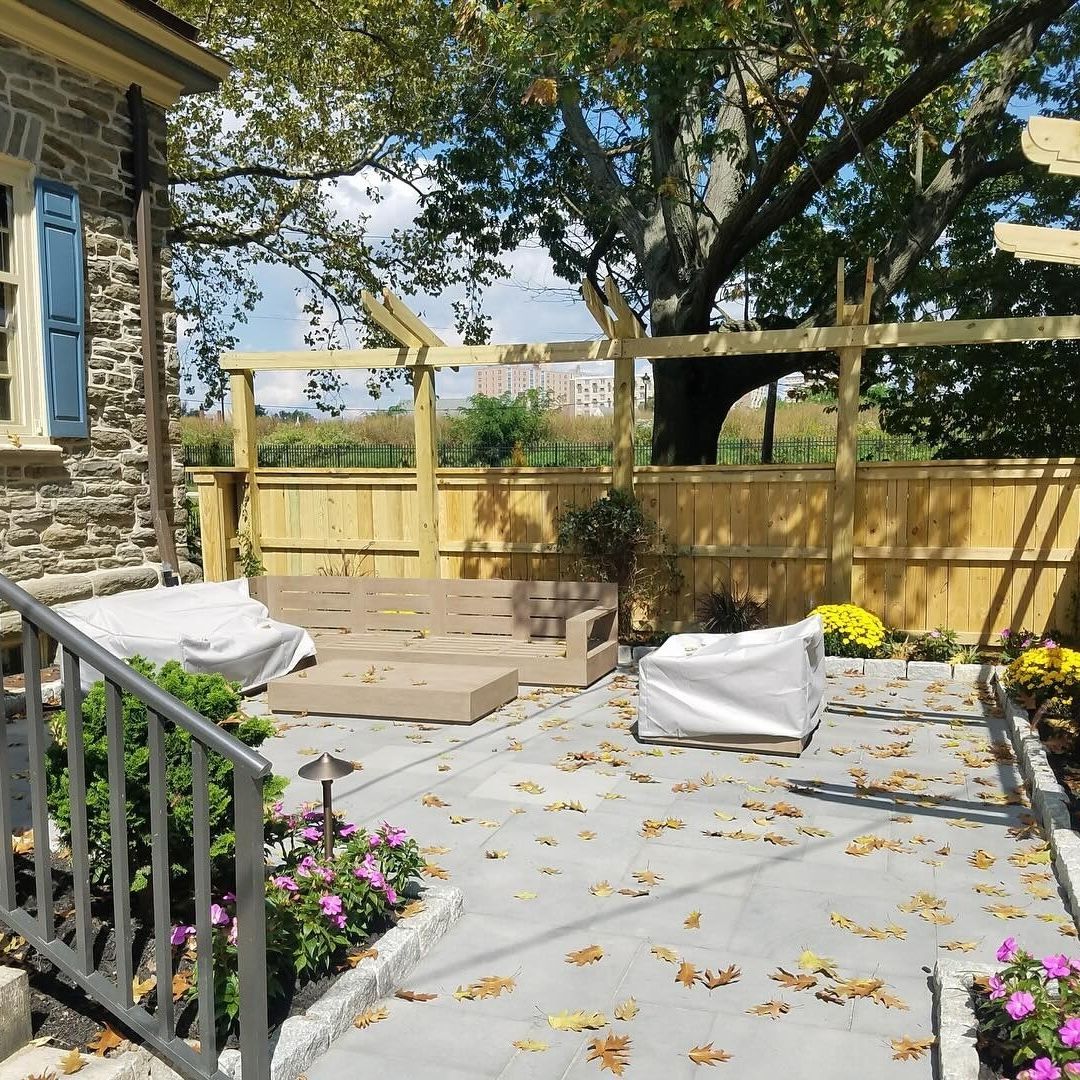 a patio covered in fall leaves
