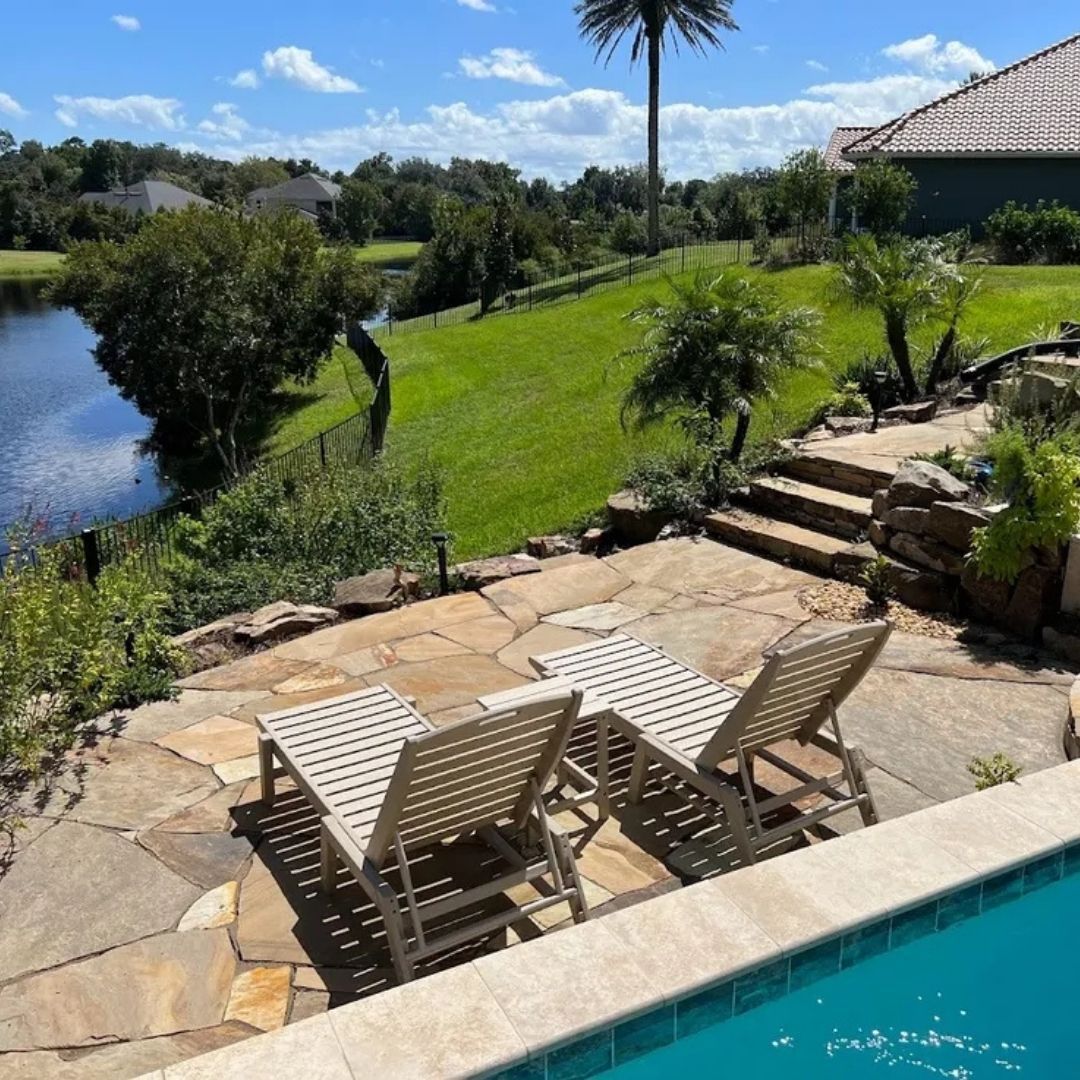 a pool with a stone patio