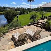 a pool with a stone patio