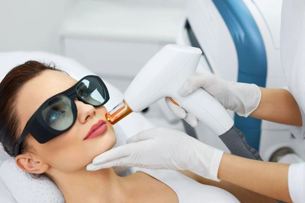 Image of a woman getting a laser treatment Image of a woman getting a laser treatment