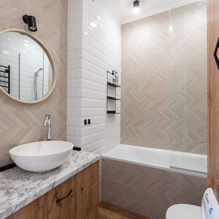 modern bathroom with intricate tile work and marble countertop 