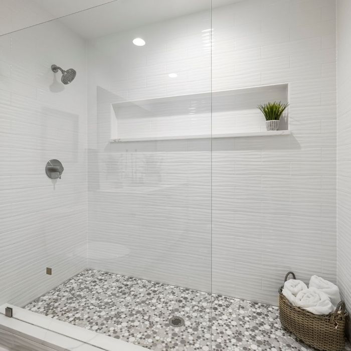 clean modern shower with tile floor and stainless steel fixtures