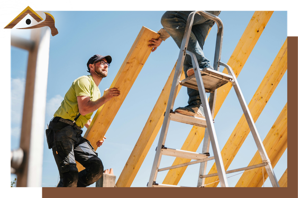 contractor handing a piece of wood to another worker