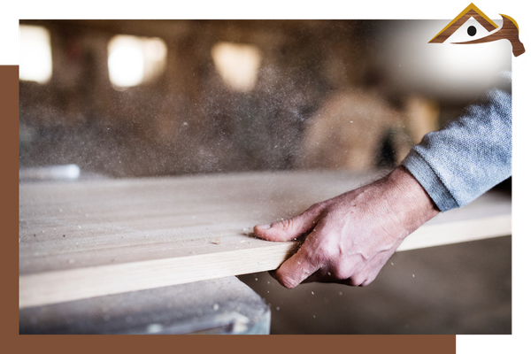 person holding a piece of wood