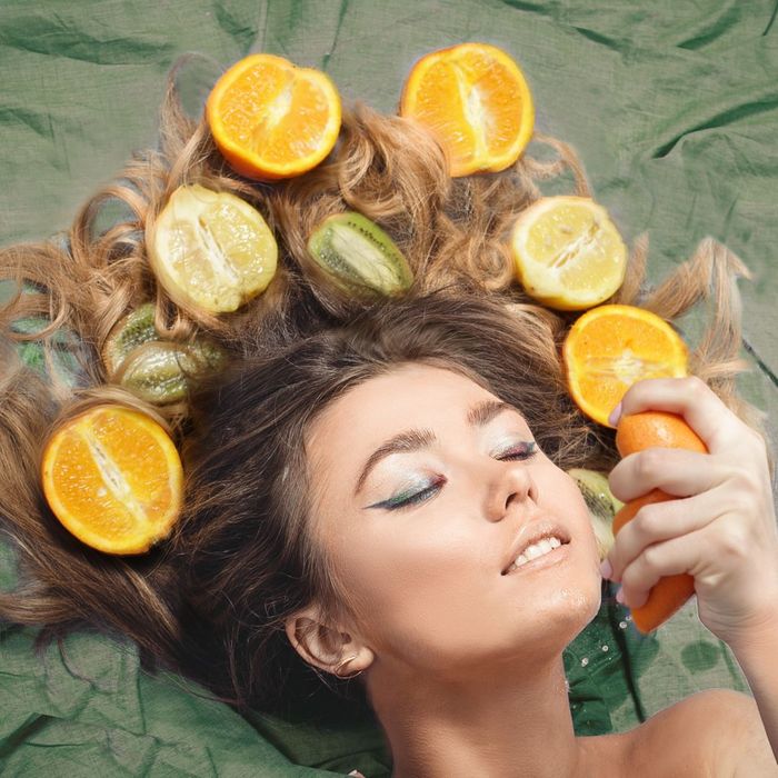 3_-_girl_laying_with_hair_spread_out_filled_with_citrus_fruits[1].jpg