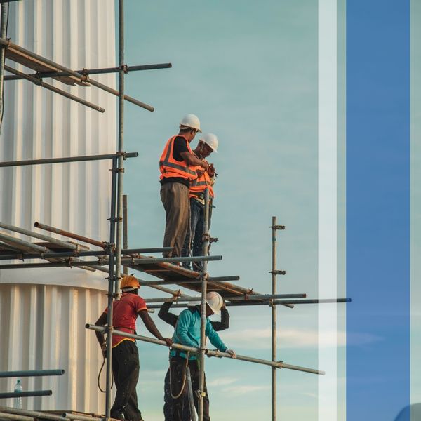 Constructoin workers standing on scaffolding