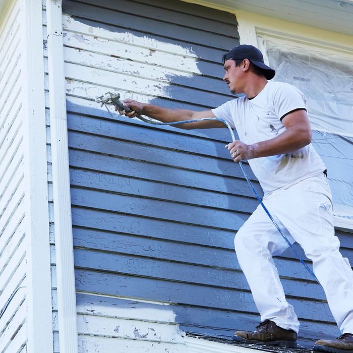Painter painting exterior of house