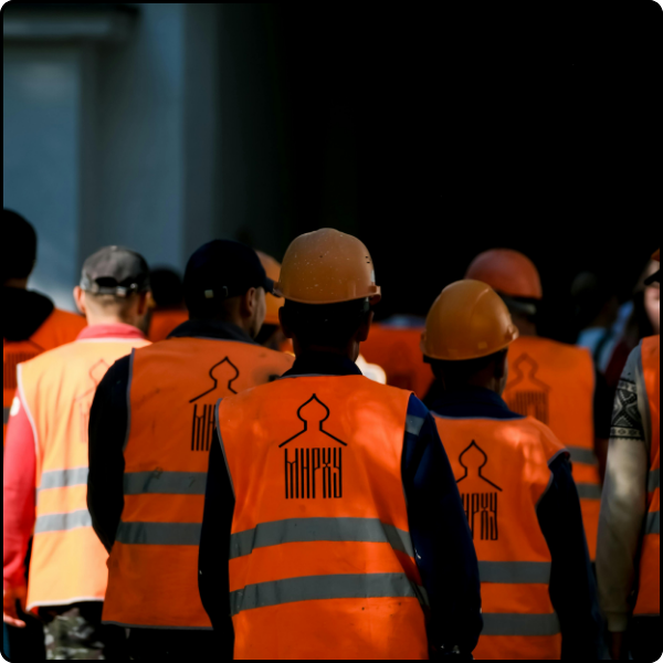 workers walking in PPE 