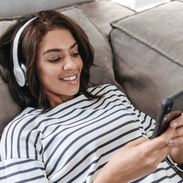 woman listening to music through headphones