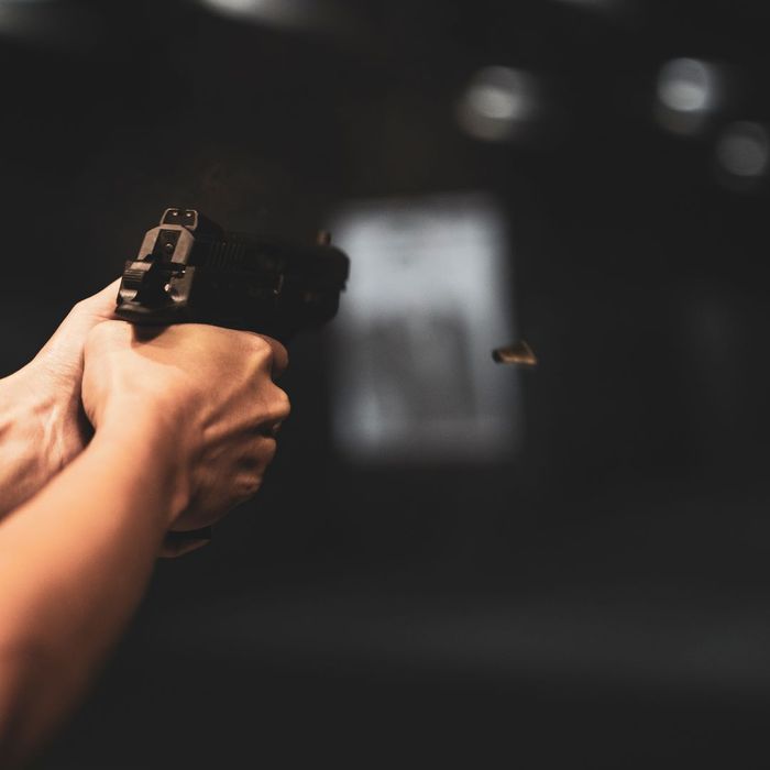 close up of a pistol discharging a bullet casing