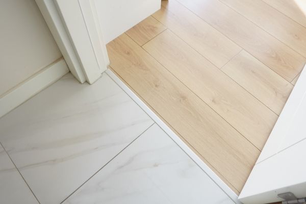 transition between clean new tile and light wood floor